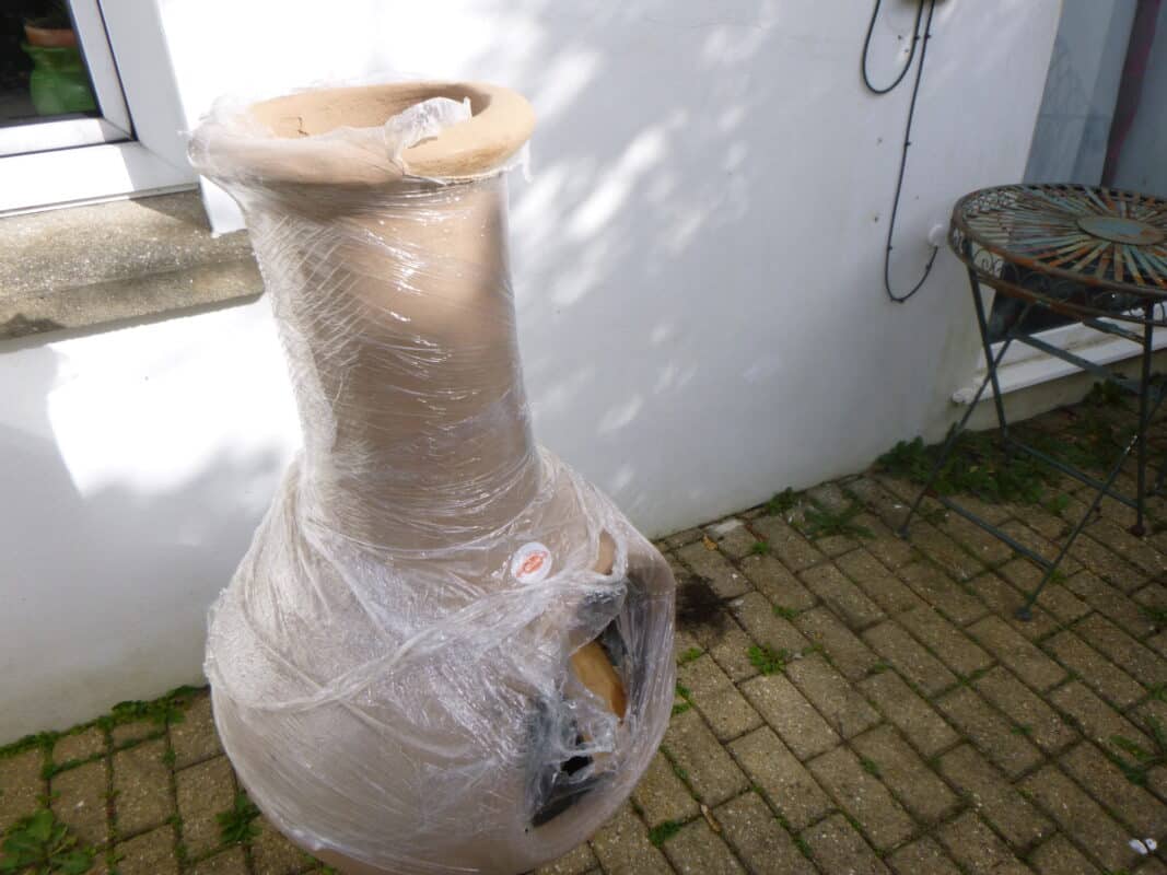A large chiminea waiting to be unwrapped